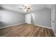Large bedroom with sleek ceiling fan and laminate floors, featuring a closet at 30 Village Dr, Cartersville, GA 30121