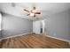 Comfortable bedroom featuring a ceiling fan, a window, and beautiful laminate floors at 30 Village Dr, Cartersville, GA 30121