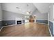 Spacious living room with vaulted ceiling, fireplace, and wood-look floors at 30 Village Dr, Cartersville, GA 30121