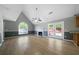 Open-concept living room featuring fireplace, wood floors, and French doors at 30 Village Dr, Cartersville, GA 30121