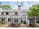 Back of the home showing a patio with furniture and surrounding greenery at 3065 Camden Way, Alpharetta, GA 30005