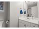 Bathroom featuring a white single sink vanity and a mirror with towel hooks at 3065 Camden Way, Alpharetta, GA 30005