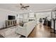 Open-concept living room with hardwood floors, a fireplace, large windows, and neutral decor at 3065 Camden Way, Alpharetta, GA 30005