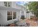 Back patio area with seating, surrounded by greenery and partial fencing at 3065 Camden Way, Alpharetta, GA 30005