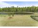 Expansive backyard featuring lush green grass and picturesque lake views, ideal for outdoor activities at 408 Cottonwood Cir, Peachtree City, GA 30269