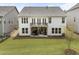 Aerial view of home's exterior and large green yard. Backyard also has an outdoor seating area at 408 Cottonwood Cir, Peachtree City, GA 30269