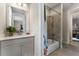Bathroom features gray vanity with white sink, bathtub with shower, neutral colored walls at 408 Cottonwood Cir, Peachtree City, GA 30269