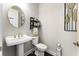 Compact powder room featuring a pedestal sink, toilet, and decorative wall accents at 408 Cottonwood Cir, Peachtree City, GA 30269