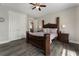 Bedroom features neutral colored walls, wood-look flooring, ceiling fan, and closet at 408 Cottonwood Cir, Peachtree City, GA 30269