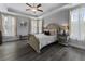 Beautiful bedroom with tray ceilings, large windows, and hardwood flooring at 408 Cottonwood Cir, Peachtree City, GA 30269