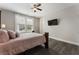 This is a light and airy bedroom with neutral walls, a TV, and a window with natural light at 408 Cottonwood Cir, Peachtree City, GA 30269