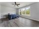 Spacious bedroom with natural light, hardwood floors, and a modern ceiling fan at 408 Cottonwood Cir, Peachtree City, GA 30269