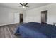 Cozy bedroom with modern ceiling fan, hardwood floors, and open doorway at 408 Cottonwood Cir, Peachtree City, GA 30269