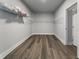 Walk-in closet featuring hardwood floors and wire shelving units for storage at 408 Cottonwood Cir, Peachtree City, GA 30269