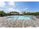 Large community pool with brick patio, lounge chairs, shaded seating and palm trees at 408 Cottonwood Cir, Peachtree City, GA 30269