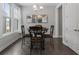 Cozy dining area featuring a round table, four chairs, and natural light from the nearby window at 408 Cottonwood Cir, Peachtree City, GA 30269
