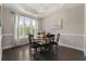Elegant dining room with hardwood floors, a chandelier, and natural light from large windows at 408 Cottonwood Cir, Peachtree City, GA 30269