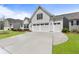 Bright home featuring a wide driveway, an attached two car garage, and a well-manicured lawn at 408 Cottonwood Cir, Peachtree City, GA 30269