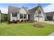 Inviting home with manicured lawn, landscaped garden bed, and an attached two car garage at 408 Cottonwood Cir, Peachtree City, GA 30269