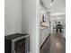 Hallway featuring a wine fridge that leads to a dining room with a chandelier at 408 Cottonwood Cir, Peachtree City, GA 30269