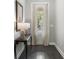 Hallway featuring hardwood floors, a side table, and a window with natural light and white curtains at 408 Cottonwood Cir, Peachtree City, GA 30269
