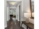 Hallway featuring hardwood floors, white trim, and an open view of the living room and dining area at 408 Cottonwood Cir, Peachtree City, GA 30269