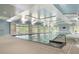 Bright indoor swimming pool area featuring large windows, lights, and light blue ceiling at 408 Cottonwood Cir, Peachtree City, GA 30269