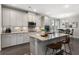 Bright kitchen features an island with bar seating, stainless appliances, and granite countertops at 408 Cottonwood Cir, Peachtree City, GA 30269