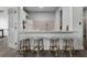 Bright kitchen featuring a breakfast bar with seating, granite countertops, and modern appliances at 408 Cottonwood Cir, Peachtree City, GA 30269