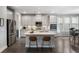 Bright kitchen features an island with bar seating, stainless appliances, and granite countertops at 408 Cottonwood Cir, Peachtree City, GA 30269