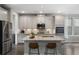 Bright kitchen features an island with bar seating, stainless appliances, and granite countertops at 408 Cottonwood Cir, Peachtree City, GA 30269