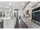 Bright open kitchen with granite counters and stainless appliances with views to the living and dining areas at 408 Cottonwood Cir, Peachtree City, GA 30269