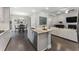 Bright kitchen featuring a center island with sink, and stainless appliances, open to dining and living area at 408 Cottonwood Cir, Peachtree City, GA 30269