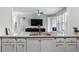 Kitchen island featuring granite countertops and stainless steel sink overlooking the living area at 408 Cottonwood Cir, Peachtree City, GA 30269