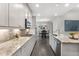 Modern kitchen featuring granite countertops, stainless appliances, and a view into the dining area at 408 Cottonwood Cir, Peachtree City, GA 30269