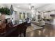 Bright living room featuring a piano, fireplace, modern furnishings, and access to outdoor spaces at 408 Cottonwood Cir, Peachtree City, GA 30269