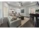 Bright living room adjacent to kitchen featuring a piano, fireplace, and modern furnishings at 408 Cottonwood Cir, Peachtree City, GA 30269