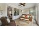 Comfortable living room with a plush sofa, armchairs, and scenic views, creating a relaxing atmosphere at 408 Cottonwood Cir, Peachtree City, GA 30269