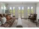 Comfortable living room with a plush sofa, armchairs, and view of the serene outdoors at 408 Cottonwood Cir, Peachtree City, GA 30269