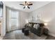 Living room with a gray sofa, patterned rug, and a large window that brings in natural light at 408 Cottonwood Cir, Peachtree City, GA 30269