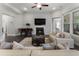 Bright living room featuring a fireplace, modern furnishings, and light grey walls at 408 Cottonwood Cir, Peachtree City, GA 30269