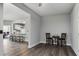 Open-concept living area with gray flooring, flowing into the kitchen and a view to the office at 408 Cottonwood Cir, Peachtree City, GA 30269