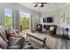 Inviting living room with scenic views, comfortable seating, and a modern ceiling fan for climate control at 408 Cottonwood Cir, Peachtree City, GA 30269