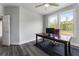 Bright office space featuring hardwood floors, large windows, and modern ceiling fan at 408 Cottonwood Cir, Peachtree City, GA 30269