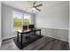 Bright office space featuring hardwood floors, large windows, and modern ceiling fan at 408 Cottonwood Cir, Peachtree City, GA 30269