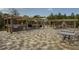 Extensive outdoor kitchen featuring a grill, pergola, and ample seating, perfect for hosting lively gatherings and enjoying outdoor dining at 408 Cottonwood Cir, Peachtree City, GA 30269