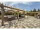 Well-equipped outdoor kitchen area with brick finishes, a built-in grill, and a pergola for shade, perfect for outdoor entertaining at 408 Cottonwood Cir, Peachtree City, GA 30269