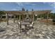 Charming outdoor seating area featuring a pergola, fireplace, and ample space for gatherings, perfect for enjoying warm summer evenings at 408 Cottonwood Cir, Peachtree City, GA 30269