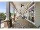 Long patio featuring brick flooring, columns, ceiling fans, and ample seating at 408 Cottonwood Cir, Peachtree City, GA 30269