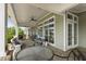 Comfortable patio seating area with tables, chairs, ceiling fans and large windows at 408 Cottonwood Cir, Peachtree City, GA 30269